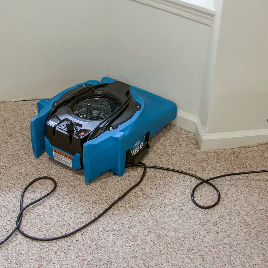 Air movers drying a hardwood floor after water extraction in Denham Springs